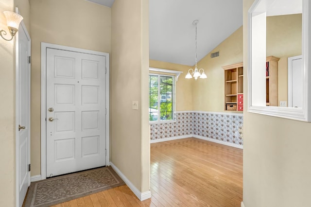 1210 E Province Dr, Fresno, CA 93720 - entryway with hardwood / wood-style floors, a chandelier, and high vaulted ceiling