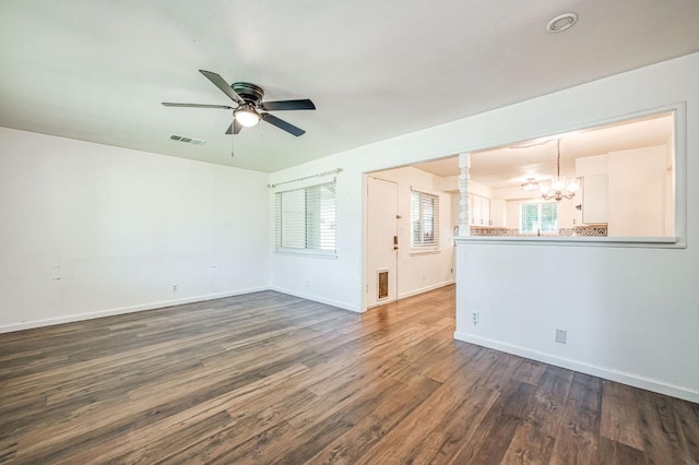1821 W Lansing Way, Fresno, CA 93705 - empty room with a chandelier, dark wood finished floors, a ceiling fan, and plenty of natural light