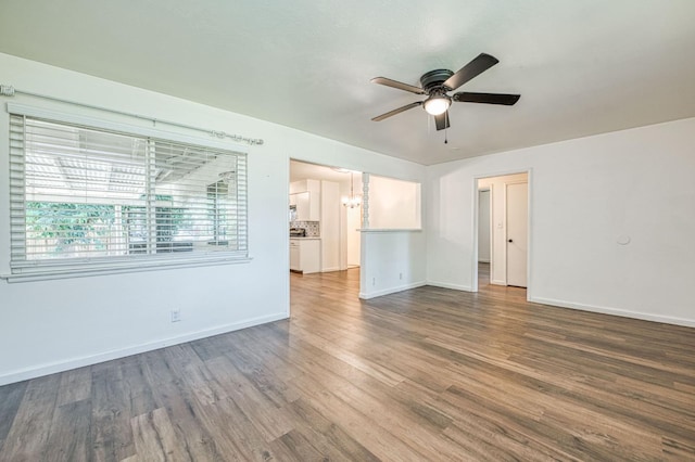 1821 W Lansing Way, Fresno, CA 93705 - empty room with ceiling fan, a chandelier, and wood finished floors