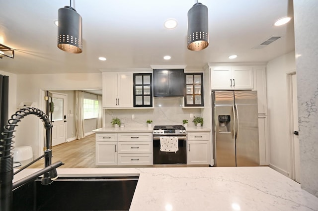 25190 Elwood Rd, Sanger, CA 93657 - kitchen with stainless steel appliances, glass insert cabinets, white cabinetry, hanging light fixtures, and recessed lighting