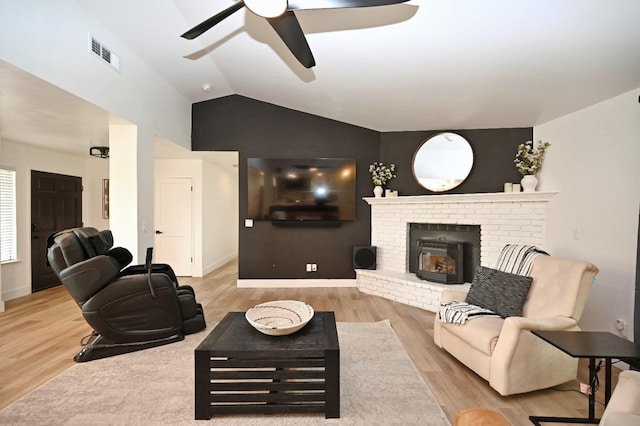 25190 Elwood Rd, Sanger, CA 93657 - living area featuring a ceiling fan, wood finished floors, vaulted ceiling, and a brick fireplace