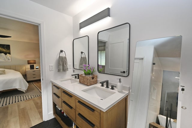 25190 Elwood Rd, Sanger, CA 93657 - full bathroom with double vanity, wood finished floors, and ensuite bath