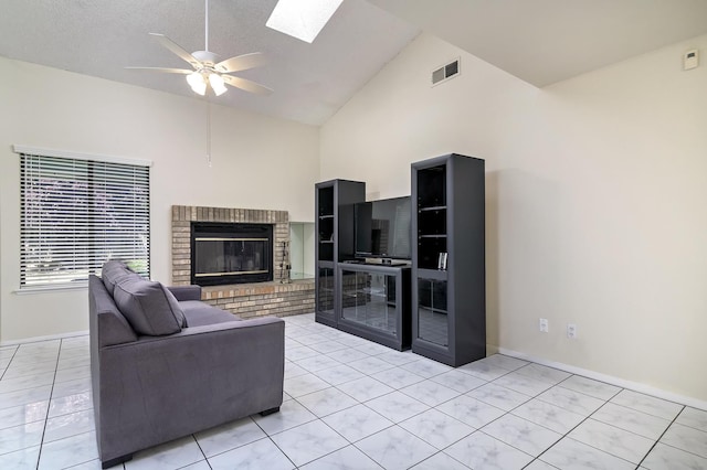 6447 N Vagedes Ave, Fresno, CA 93711 - living area with a fireplace, a ceiling fan, light tile patterned floors, high vaulted ceiling, and a skylight