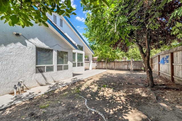 5811 W Beechwood Ave, Fresno, CA 93722 - fenced backyard with a patio area