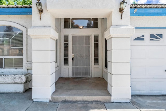 5811 W Beechwood Ave, Fresno, CA 93722 - property entrance with a garage and stucco siding