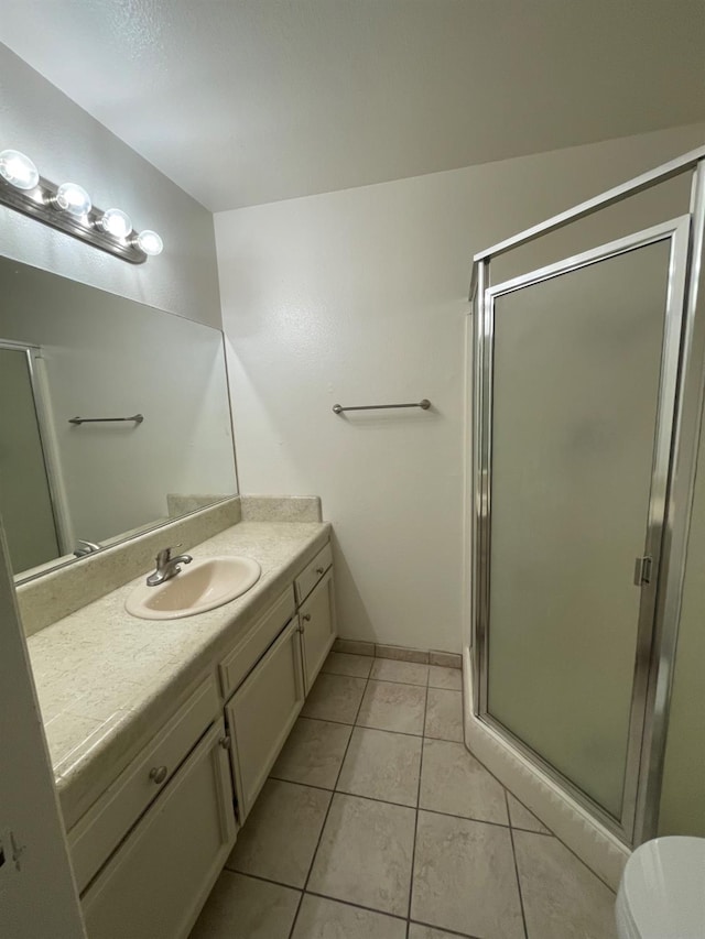 1027 W Dakota Ave Unit 102, Fresno, CA 93705 - full bathroom featuring vanity, a stall shower, and tile patterned flooring