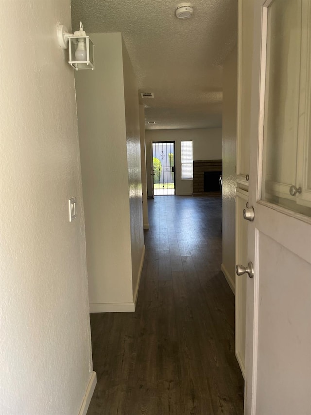 1027 W Dakota Ave Unit 102, Fresno, CA 93705 - hallway featuring dark wood finished floors and a textured ceiling