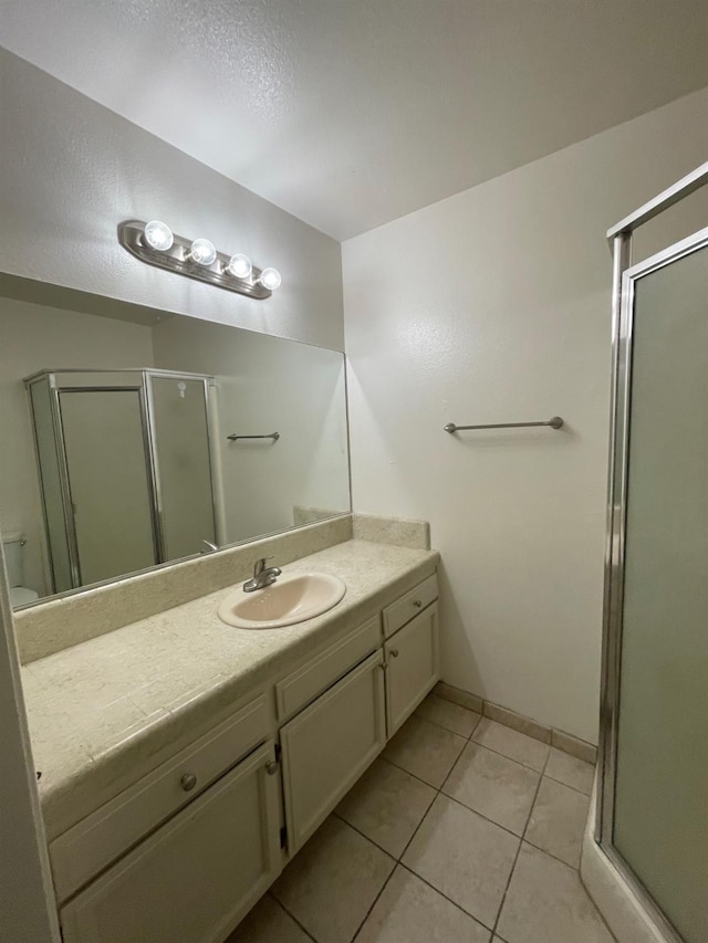 1027 W Dakota Ave Unit 102, Fresno, CA 93705 - bathroom featuring vanity, a shower stall, and tile patterned floors