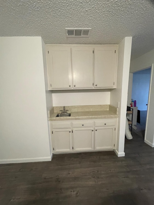 1027 W Dakota Ave Unit 102, Fresno, CA 93705 - kitchen featuring white cabinetry, light countertops, and a textured ceiling