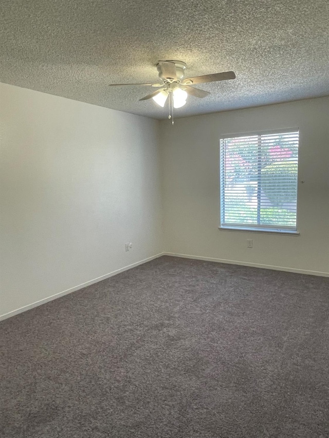 1027 W Dakota Ave Unit 102, Fresno, CA 93705 - spare room featuring ceiling fan, dark colored carpet, and a textured ceiling