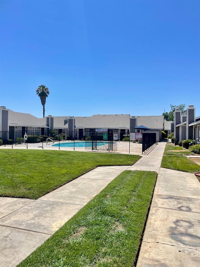 1027 W Dakota Ave Unit 102, Fresno, CA 93705 - view of community featuring a swimming pool