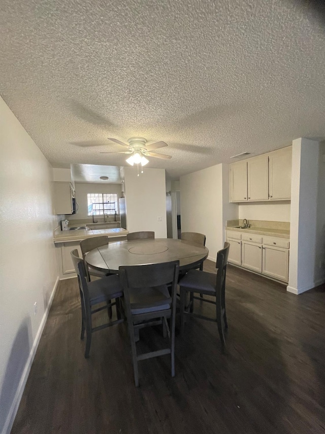 1027 W Dakota Ave Unit 102, Fresno, CA 93705 - dining space with dark wood-style flooring, a ceiling fan, and a textured ceiling