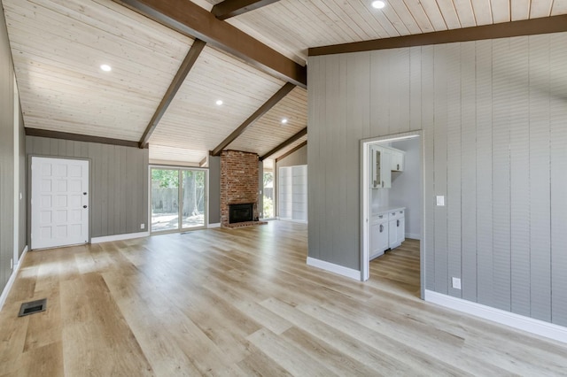 1904 S Fairway Ave, Fresno, CA 93727 - unfurnished living room featuring light wood-type flooring, a fireplace, high vaulted ceiling, a wood ceiling with exposed beams, and wooden walls