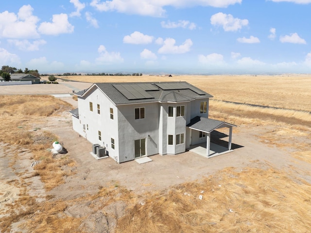 36950 Pauline Ave, Madera, CA 93636 - back of property with stucco siding, solar panels, a view of rural / pastoral area, and a shingled roof