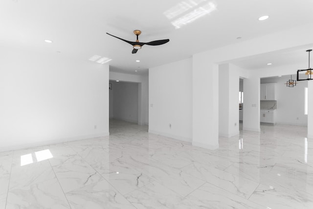 36950 Pauline Ave, Madera, CA 93636 - empty room featuring light marble finish flooring, recessed lighting, a chandelier, and a ceiling fan