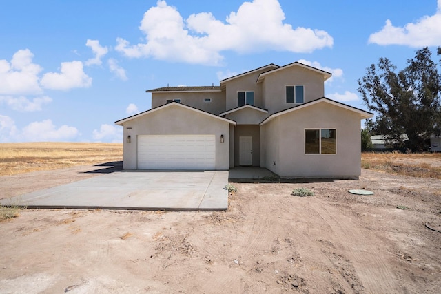36950 Pauline Ave, Madera, CA 93636 - view of front of house with concrete driveway, a garage, and stucco siding