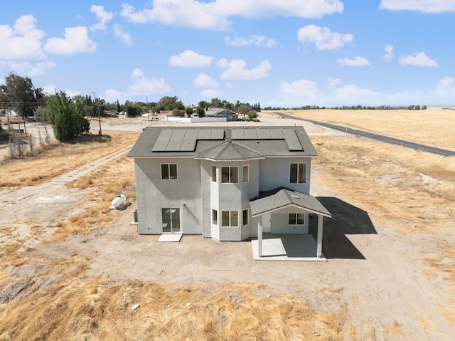 36950 Pauline Ave, Madera, CA 93636 - back of property with a patio, stucco siding, roof mounted solar panels, and a view of rural / pastoral area