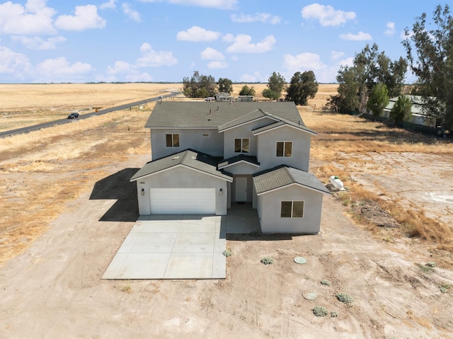 36950 Pauline Ave, Madera, CA 93636 - traditional home featuring a rural view, concrete driveway, stucco siding, and a garage