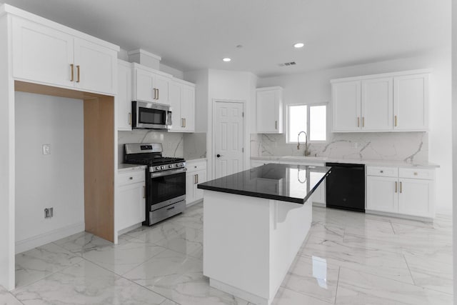 36950 Pauline Ave, Madera, CA 93636 - kitchen with appliances with stainless steel finishes, light marble finish flooring, white cabinets, recessed lighting, and a kitchen island