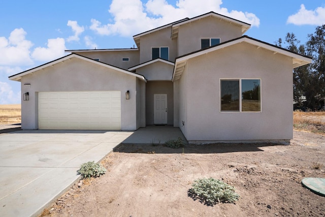 36950 Pauline Ave, Madera, CA 93636 - view of front of home featuring stucco siding, a garage, and concrete driveway