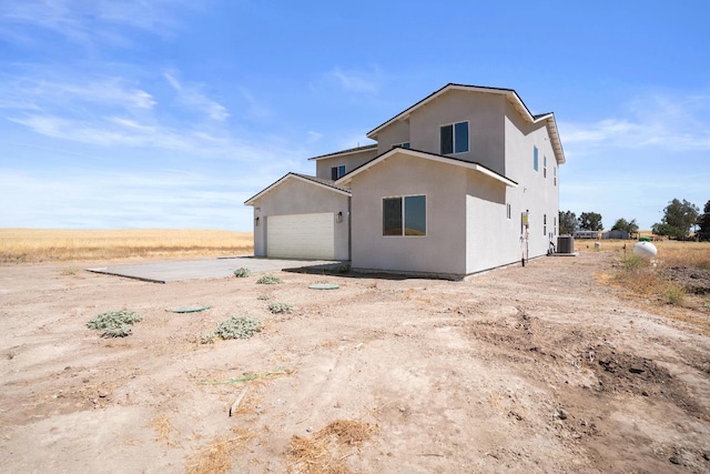 36950 Pauline Ave, Madera, CA 93636 - view of side of home with driveway, an attached garage, and stucco siding