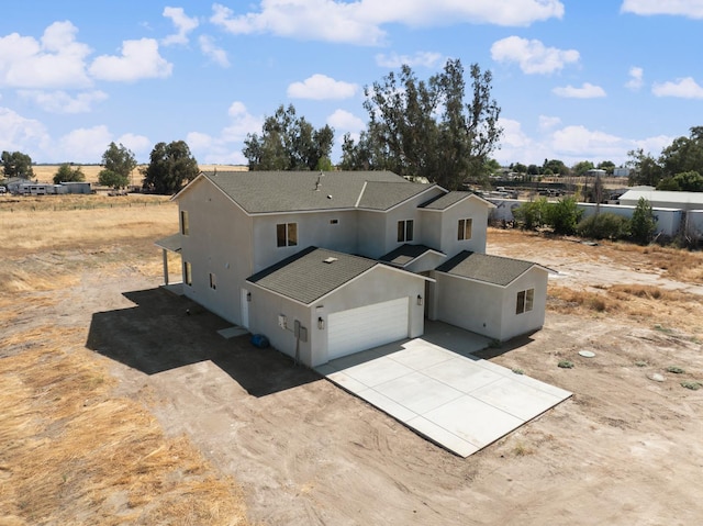 36950 Pauline Ave, Madera, CA 93636 - back of house featuring stucco siding, concrete driveway, and an attached garage
