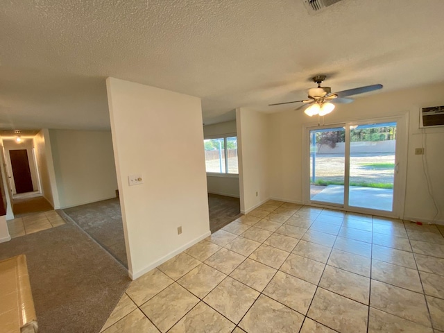12173 Rd 36, Madera, CA 93636 - spare room with a textured ceiling, a ceiling fan, light tile patterned floors, and an AC wall unit