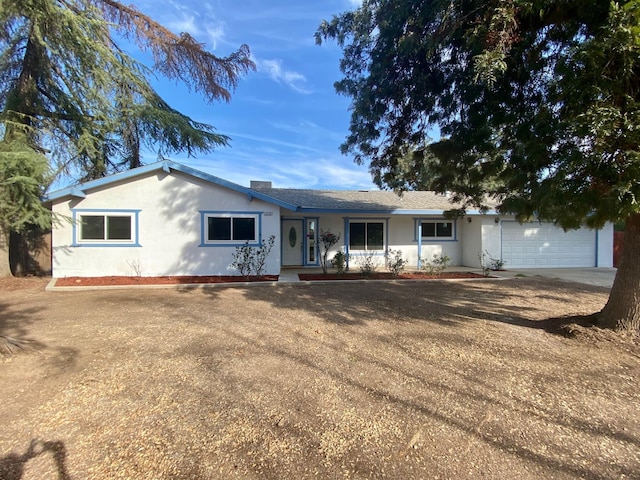 12173 Rd 36, Madera, CA 93636 - view of front of property featuring stucco siding, concrete driveway, and a garage