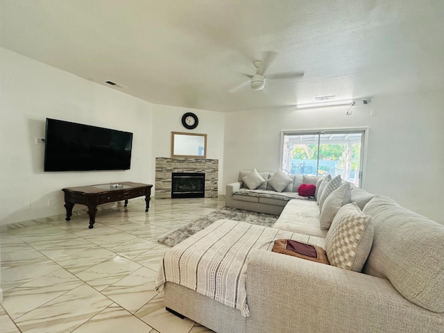 924 Palm Ave, Fowler, CA 93625 - living area with light marble finish floors, a ceiling fan, and a fireplace