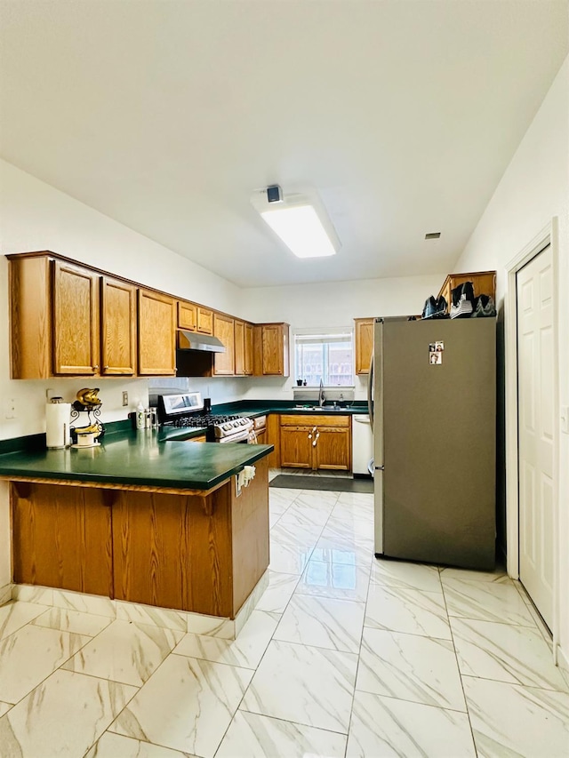 924 Palm Ave, Fowler, CA 93625 - kitchen featuring appliances with stainless steel finishes, brown cabinets, a peninsula, and under cabinet range hood