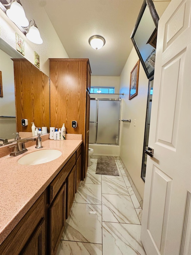 924 Palm Ave, Fowler, CA 93625 - bathroom featuring marble look tile flooring, vanity, and combined bath / shower with glass door