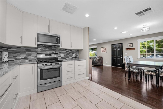1440 E Fountain Way, Fresno, CA 93704 - kitchen with stainless steel appliances, tasteful backsplash, plenty of natural light, and recessed lighting