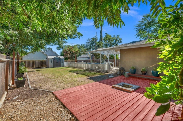 1440 E Fountain Way, Fresno, CA 93704 - wooden deck featuring a fenced backyard and a storage shed