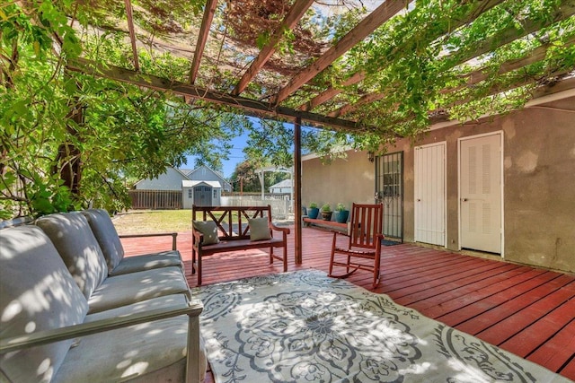 1440 E Fountain Way, Fresno, CA 93704 - deck featuring a storage unit, a fenced backyard, a pergola, and an outdoor hangout area