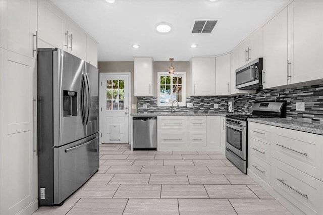 1440 E Fountain Way, Fresno, CA 93704 - kitchen featuring appliances with stainless steel finishes, backsplash, white cabinetry, and recessed lighting