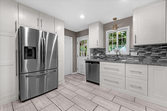 1440 E Fountain Way, Fresno, CA 93704 - kitchen featuring appliances with stainless steel finishes, backsplash, dark stone counters, recessed lighting, and white cabinets