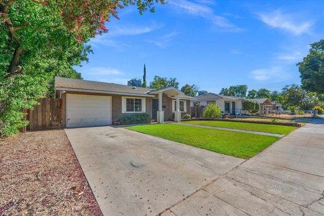 1440 E Fountain Way, Fresno, CA 93704 - ranch-style home with concrete driveway, an attached garage, and stucco siding