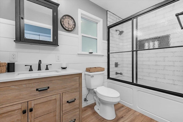 1440 E Fountain Way, Fresno, CA 93704 - full bath featuring vanity, shower / bath combination with glass door, and wood finished floors