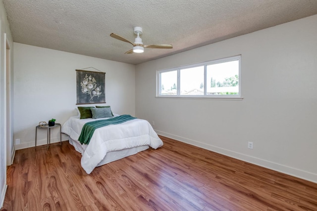 1648 Purvis Ave, Clovis, CA 93611 - bedroom featuring wood finished floors, a textured ceiling, and ceiling fan