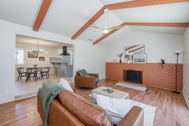 1648 Purvis Ave, Clovis, CA 93611 - living area featuring a brick fireplace, wood finished floors, a chandelier, and a ceiling fan
