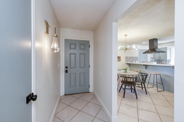 1648 Purvis Ave, Clovis, CA 93611 - foyer entrance with light tile patterned flooring, a textured ceiling, and a chandelier