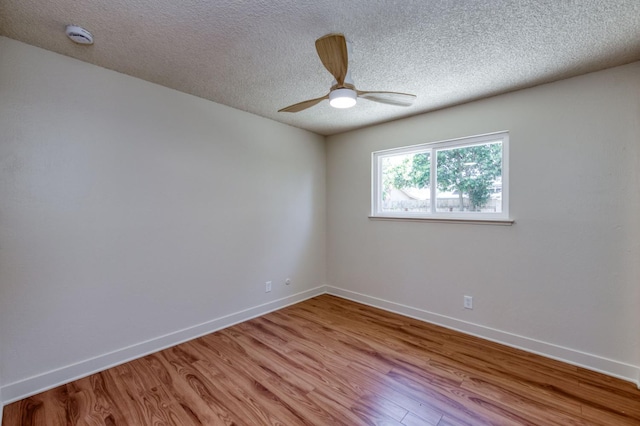 1648 Purvis Ave, Clovis, CA 93611 - unfurnished room with light wood-style floors, a ceiling fan, a textured ceiling, and a smoke detector
