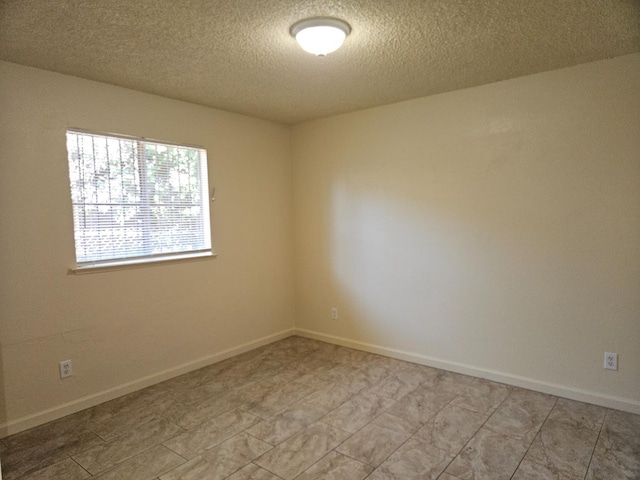 1490 N First, Fresno, CA 93703 - empty room with a textured ceiling and baseboards