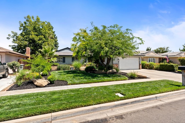 2344 E Menlo Ave, Fresno, CA 93710 - obstructed view of property with driveway, an attached garage, and a front lawn