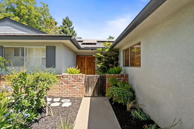 2344 E Menlo Ave, Fresno, CA 93710 - view of property exterior featuring stucco siding and solar panels