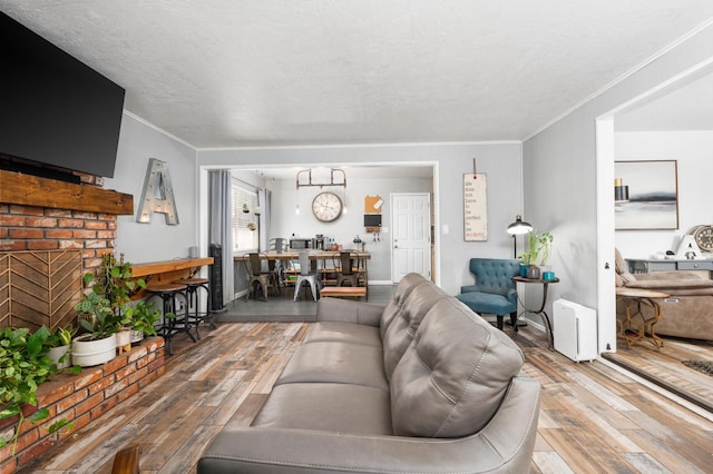 2344 E Menlo Ave, Fresno, CA 93710 - living area with wood-type flooring, crown molding, and a textured ceiling