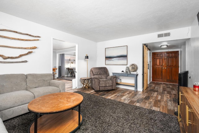 2344 E Menlo Ave, Fresno, CA 93710 - living area featuring dark wood-style flooring and a textured ceiling
