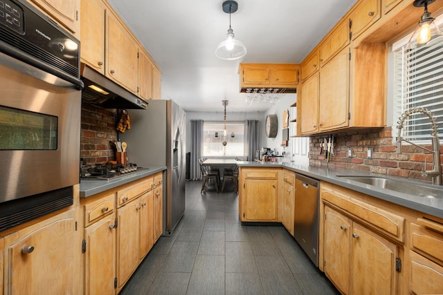 2344 E Menlo Ave, Fresno, CA 93710 - kitchen with stainless steel appliances, under cabinet range hood, tasteful backsplash, a peninsula, and decorative light fixtures