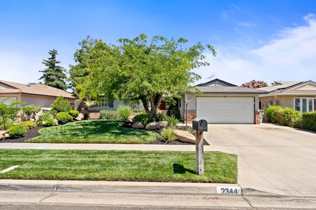 2344 E Menlo Ave, Fresno, CA 93710 - ranch-style house with a garage, driveway, a front lawn, and brick siding