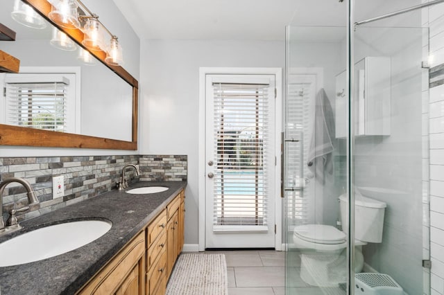 2344 E Menlo Ave, Fresno, CA 93710 - full bathroom featuring double vanity, decorative backsplash, tile patterned flooring, and a shower stall